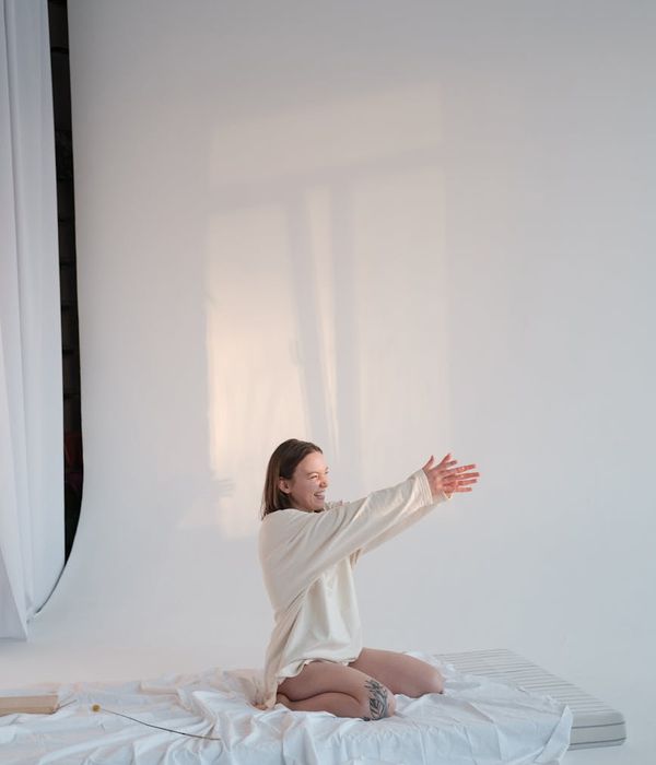 Woman in a calm pose, radiating gentle energy with cyan light effects.